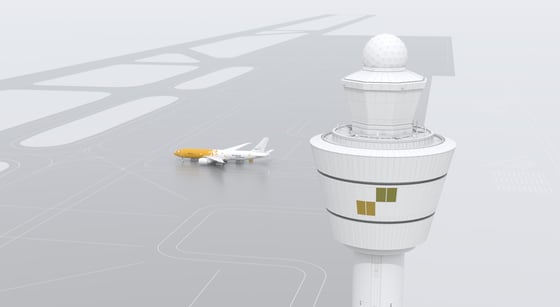 A tower can be seen from a higher perspective. A cargo plane is in the background.